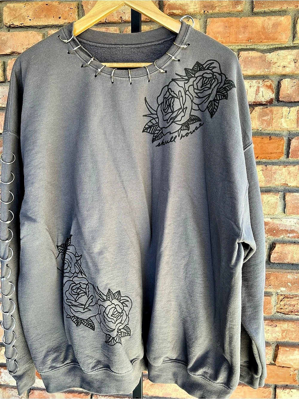 Skull House Designs pierced hoop sweatshirt," "grunge rose” graphic crewneck sz